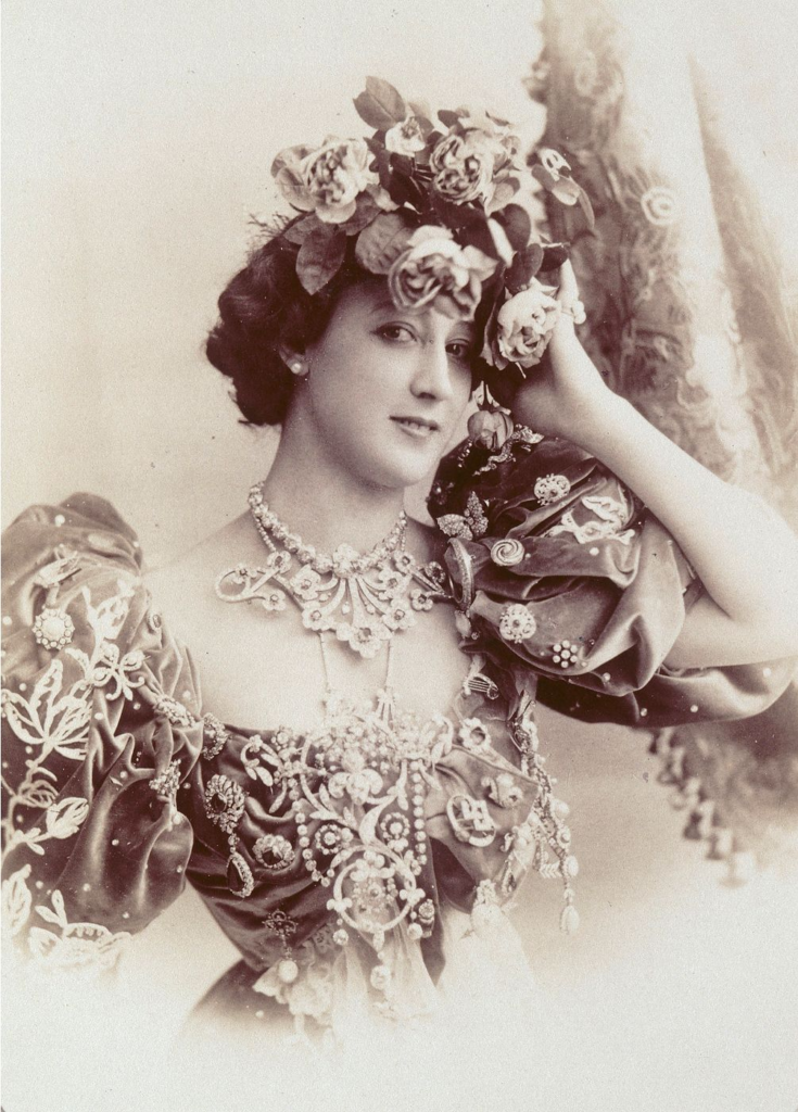Carolina Otero in a jewel-studded gown at her peak of fame. Portraits like this were mass-sold as postcards across Europe  an early form of celebrity paparazzi.

