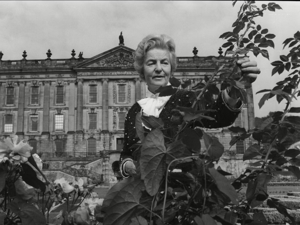 Deborah pruning roses at Chatsworth, the house she rebuilt from near-ruin into one of England's most visited estates.