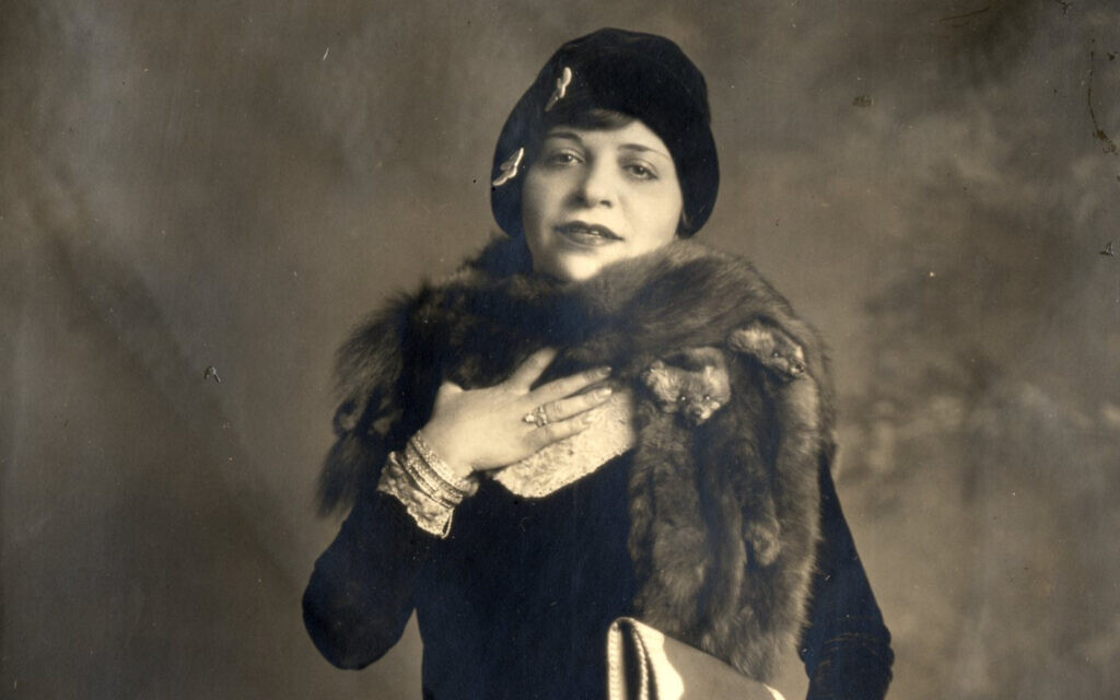 Polly Adler, c. 1920s. The fur stole, the rings, the steady gaze of a woman who owed nobody anything. She had arrived in New York with nothing. She made sure it never showed.bing images.
