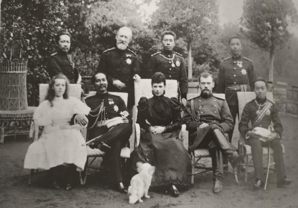 Public Domain Olga Alexandrovna (far left) with Empress Marie Feodorovna and the future Nicholas II, photographed at a diplomatic reception in the early 1890s.
