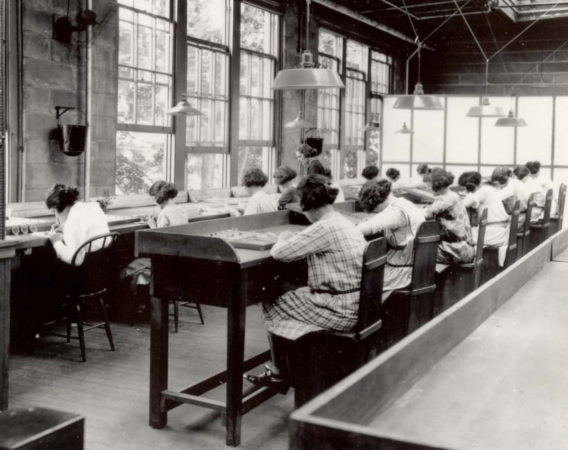 NIST Women paint watch dials at the United States Radium Corporation in New Jersey, circa 1922. Each brush tip they touched to their lips carried a slow and invisible poison.