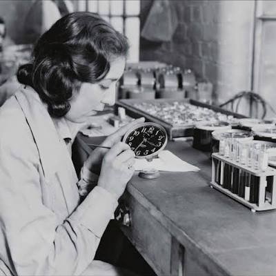 A dial painter applies radium paint to a clock face, circa 1920s. The paint that made the dials glow in the dark was silently destroying her bones.