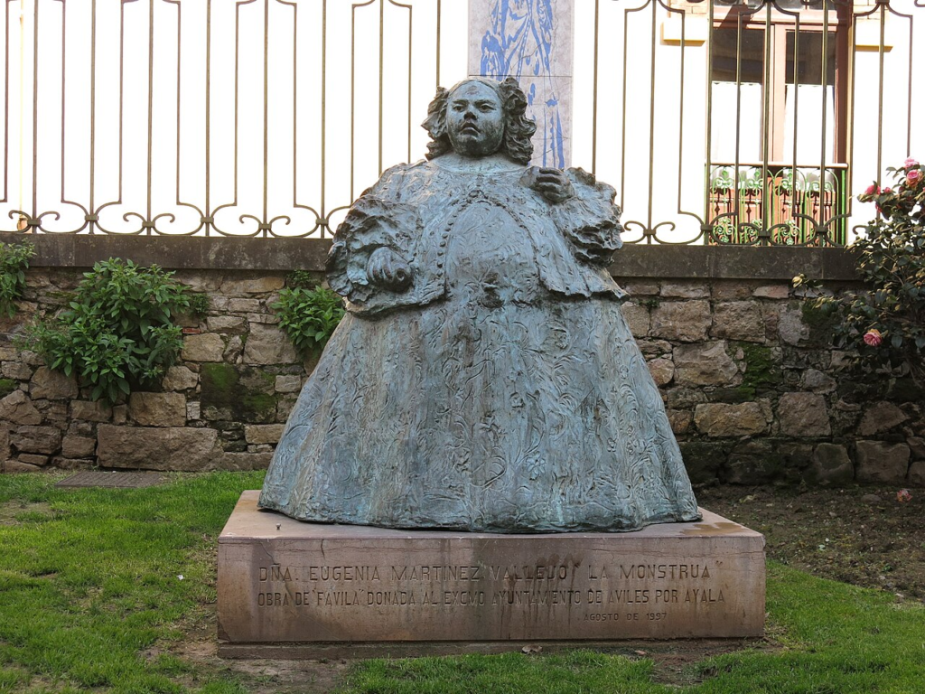 A bronze statue of Eugenia Martínez Vallejo in Avilés, Spain, made in 1997. It's based on her famous portrait in the red dress.